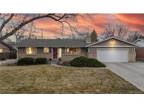 Charming single-story home with brick accents, attached garage, and a well-maintained front yard at 1823 S Carr St, Lakewood, CO 80232