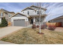 Charming two-story home featuring a two-car garage, stone accents, and a cozy front porch at 2033 E 167Th Way, Thornton, CO 80602