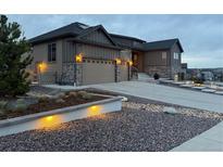 Charming home showcasing a two-car garage, stone accents, manicured front yard, and inviting curb appeal at 8023 Gore Creek Ln, Littleton, CO 80125