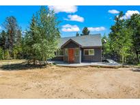 Charming exterior view of the home with a wooden deck and natural surroundings at 10411 Dowdle Dr, Golden, CO 80403