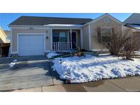 Charming single Gathering home featuring a front porch and attached one car garage during winter at 15614 E 51St Pl, Denver, CO 80239