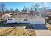 Charming one-story home with freshly painted exterior, well-maintained lawn, and attached garage at 10930 W Tulane Ave, Littleton, CO 80127