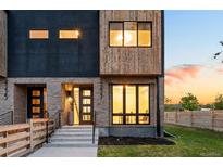 Modern two-story home with brick and wood accents, large windows and private yard at 4227 Mariposa St, Denver, CO 80211