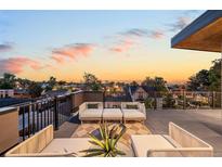 Relax on the rooftop deck featuring comfortable seating and stunning sunset views at 4227 Mariposa St, Denver, CO 80211