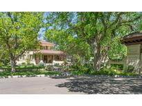 Charming home exterior with lush landscaping, mature trees, and a red-tiled roof at 395 N Franklin St, Denver, CO 80218