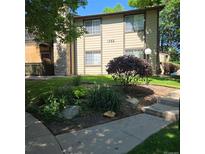 Inviting exterior view featuring a well-maintained lawn and a charming stone accent on the facade at 1755 S Pitkin St # B, Aurora, CO 80017