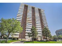 View of the Polo Club condominium building showcasing the architecture and landscaping at 3131 E Alameda Ave # 1503, Denver, CO 80209