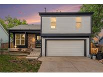 Two-story home featuring a garage and front yard at 11407 W 103Rd Ave, Broomfield, CO 80021