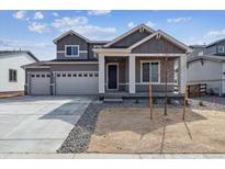Charming two-story home with a three-car garage, neutral paint, and manicured front yard at 14378 Heritage Dr, Mead, CO 80504