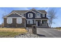 Charming two-story home with stone accents and a well-manicured lawn at 5285 La Quinta Cir, Elizabeth, CO 80107