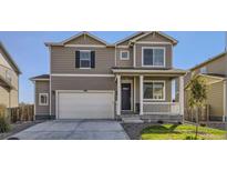 Two-story house with a large garage and well-maintained lawn at 2300 Mountain Sky Dr, Fort Lupton, CO 80621