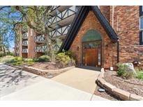 Inviting Dublin Terrace entrance featuring a brick facade, a garden area, and well-maintained landscaping at 1350 Josephine St # 307, Denver, CO 80206