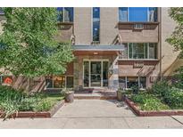 The building entrance features stone accents, planters, and ample sunlight at 10 N Ogden St # 5, Denver, CO 80218