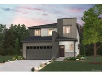 Modern two-story home with gray siding, a two-car garage, and a landscaped front yard at 18958 E 94Th Pl, Commerce City, CO 80022