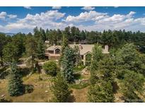 Secluded property surrounded by trees with stone retaining walls, offering privacy and a natural setting at 1682 Montane E Dr, Golden, CO 80401