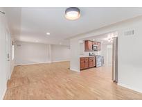 Spacious living area with hardwood floors connecting to the kitchen, featuring modern appliances and ample space at 3501 W 53Rd Ave, Denver, CO 80221
