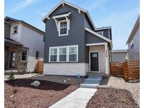 Charming two-story home featuring sleek vertical siding and a well-manicured front yard at 23920 E 34Th Ave, Aurora, CO 80019
