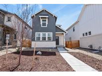 Charming two-story home featuring vertical siding, a stone accent wall, and a well-manicured front yard at 23920 E 34Th Ave, Aurora, CO 80019