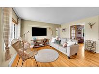 Cozy living room featuring hardwood floors, a comfortable sofa, and stylish decor at 1243 S Tejon St, Denver, CO 80223