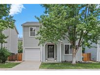 Charming two-story home with a well-manicured front yard, and a one car garage at 11845 W Tulane Dr, Morrison, CO 80465