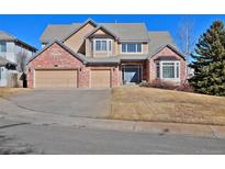 Charming two-story home with brick accents, a three car garage and well-manicured lawn at 2713 Slate Ct, Superior, CO 80027