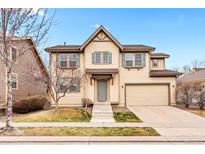 Charming two-story home with a two-car garage, neutral color palette, and well-maintained front lawn at 3815 Red Deer Trl, Broomfield, CO 80020