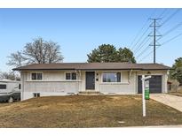 Charming single-story home with a brick facade and well-maintained front yard at 8097 E Lehigh Dr, Denver, CO 80237