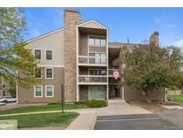 Inviting exterior view of a multi-story condo building with balconies and manicured landscaping in a residential area at 4896 S Dudley St # 8, Littleton, CO 80123