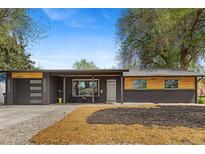 Charming exterior of a brick home featuring a modern garage and inviting front porch at 982 S Holly St, Denver, CO 80246