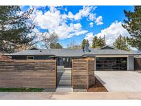 Stylish single-story home with a modern fence, gray brick, updated garage door, and professionally landscaped front yard at 3275 19Th St, Boulder, CO 80304