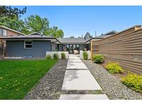 Charming single-story home featuring a well-maintained lawn, stepping stone walkway, and beautifully landscaped front yard at 3275 19Th St, Boulder, CO 80304