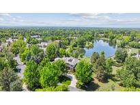 Stunning aerial view of a luxurious home nestled among lush greenery and a serene lake at 13 Buell Mansion Pkwy, Englewood, CO 80113