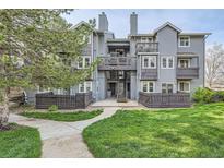 Attractive multi-level condominium with lawn, mature trees, and wood-look fencing at 7895 Allison Way # 203, Arvada, CO 80005