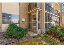 Exterior view of the entrance to a condo with a screened in porch and beautiful landscaping at 3022 S Wheeling Way # 109, Aurora, CO 80014