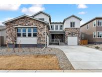 Beautiful home with stone accents, a well-manicured lawn, and a modern driveway at 2536 Wesley Ln, Lafayette, CO 80026