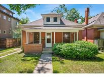 Charming brick home with a cozy front porch and well-maintained lawn at 4461 Vrain St, Denver, CO 80212