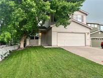 Charming two-story home with attached garage and a well-maintained front yard at 21767 Silver Meadow Ln, Parker, CO 80138