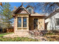 Charming two-story home featuring colorful accents, stone architecture, and an inviting front entrance at 3147 Umatilla St, Denver, CO 80211