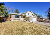 Charming two-story home with brick accents, attached garage, and well-maintained front yard at 15017 E Greenwood Pl, Aurora, CO 80014