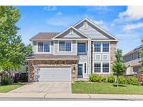 Charming two-story home with a two car garage and stone and siding exterior at 15021 Josephine St, Thornton, CO 80602