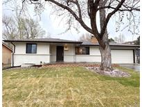 Charming ranch style home with a brick accent wall, new paint, mature landscaping and a spacious two car garage at 10253 W 68Th Way, Arvada, CO 80004