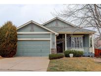 Charming single-Gathering home featuring a well-manicured front yard and an attached two-car garage at 16159 W 70Th Pl, Arvada, CO 80007
