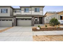 Charming two-story home with a concrete driveway, neutral siding, and a well-manicured front yard at 6616 N Nepal St, Aurora, CO 80019