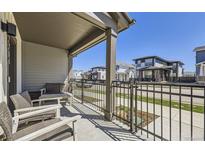 Cozy covered front porch with seating and a view of the street at 2214 Central Park Way, Superior, CO 80027