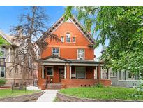 Charming red brick two-story home featuring a welcoming front porch and classic architectural details at 1136 N Logan St # 8, Denver, CO 80203