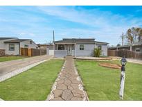 Charming single-story home with a well-manicured lawn and welcoming stone pathway at 1841 Ruth Dr, Thornton, CO 80229