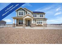 Charming two-story home with a welcoming front porch, solar panels, and a beautifully graveled front yard at 16360 Paris Way, Brighton, CO 80602