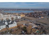 An aerial view shows the property next to Sloan's Lake and surrounding neighborhood with modern buildings at 1571 Sheridan Blvd, Lakewood, CO 80214