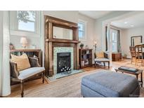 Inviting living room featuring a charming fireplace, hardwood floors, and comfortable seating at 493 S Lincoln St, Denver, CO 80209