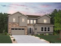 Charming two-story home featuring stone accents, gray siding and a two-car garage at 13770 Emerald Lake St, Parker, CO 80138